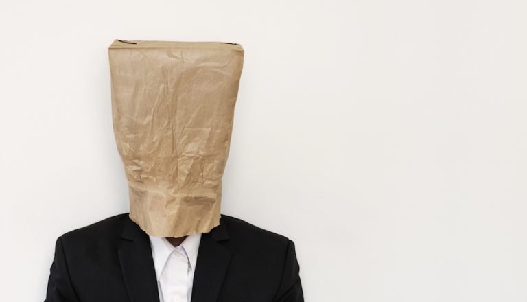 person wearing brown paper bag on head