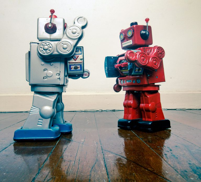 silver and red robots fighting