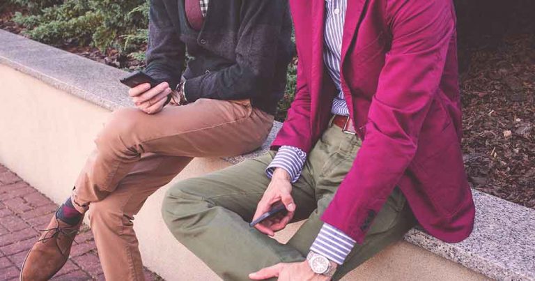 men in jackets using smartphones to engage in conversational commerce