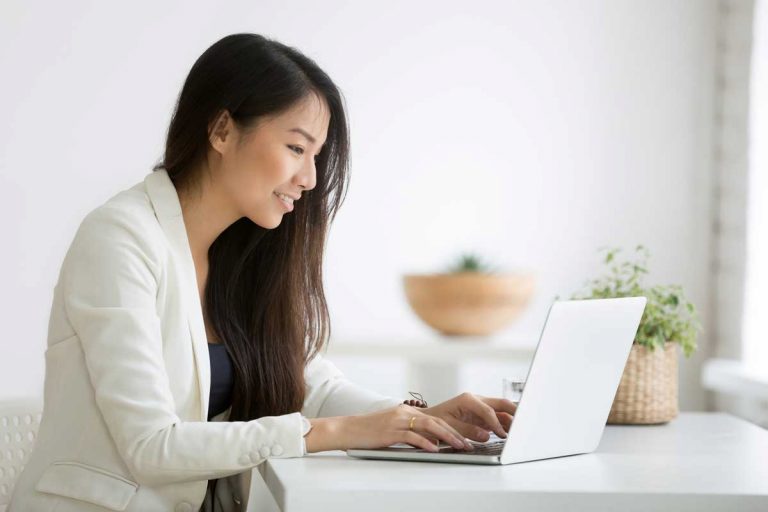 woman smiling at email reply illustrating building customer loyalty with email automation