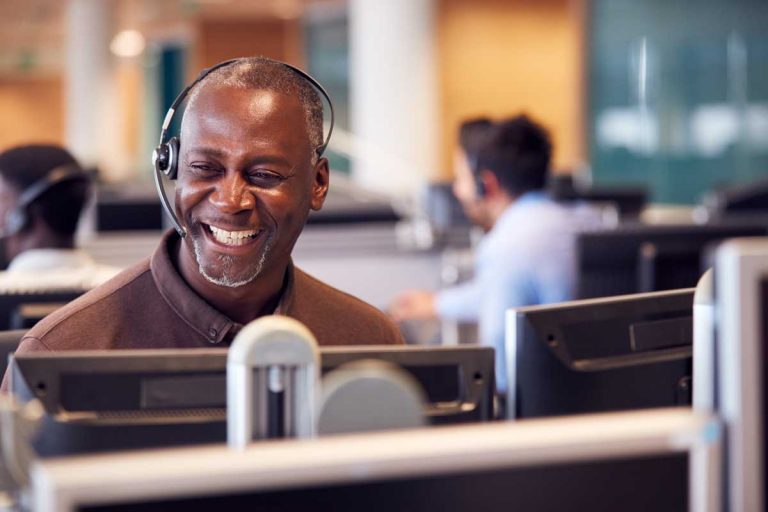 smiling call center agent making use of call center automation for email